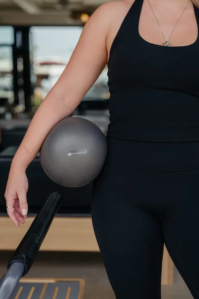 Client using a Pilates ring during a core exercise