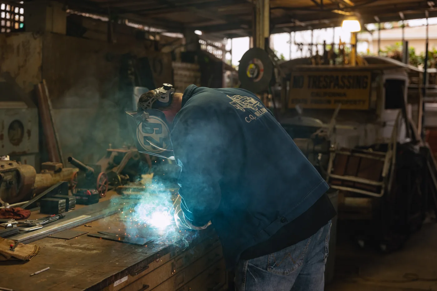 Close-up of an arc weld throwing sparks across a steel workpiece