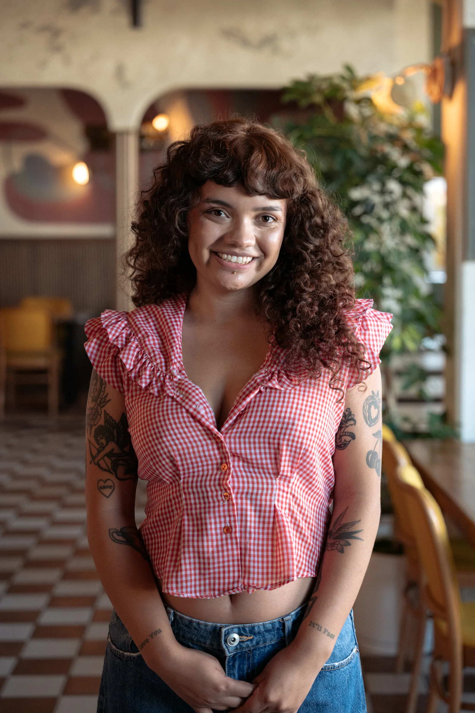 Portrait of a smiling staff member standing in the dining room