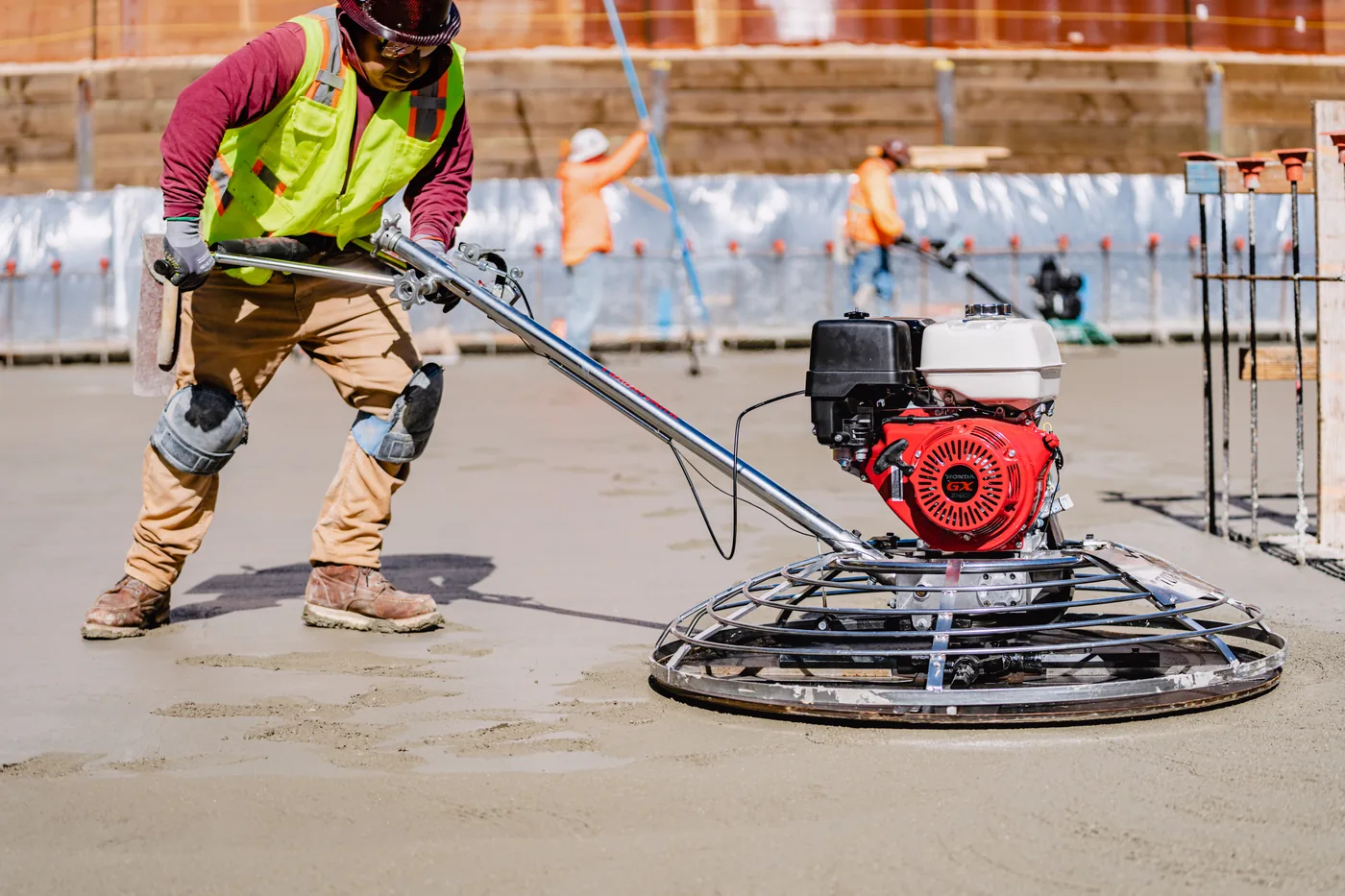 Power trowel spinning across a freshly poured slab